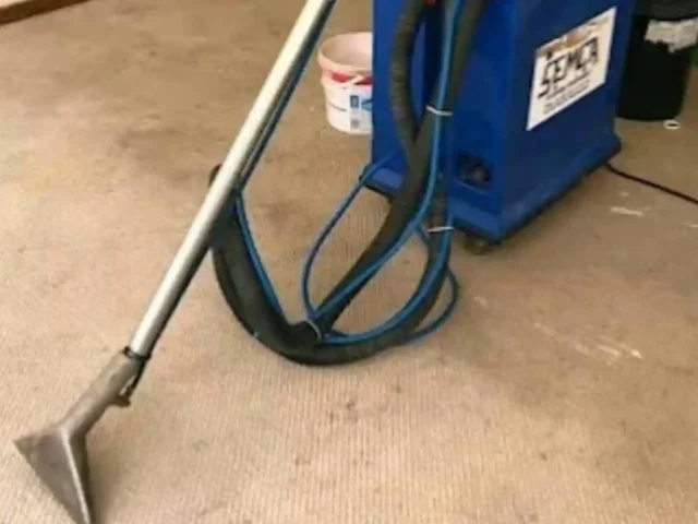Carpet cleaning machine in use on a household carpet